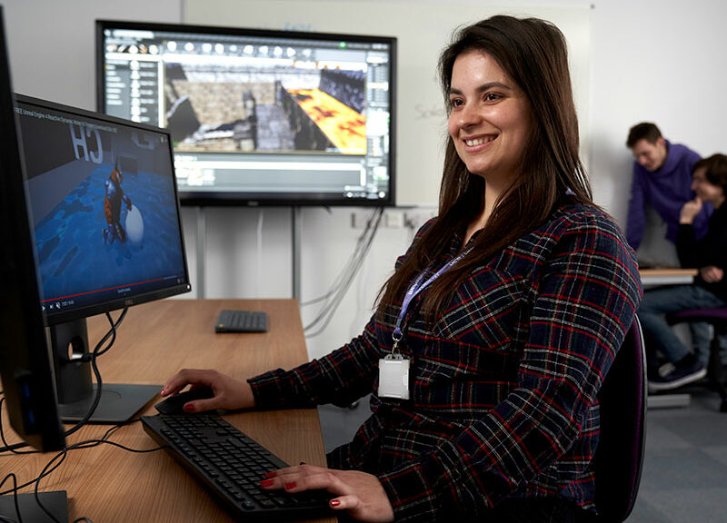 student using multi-screened computer