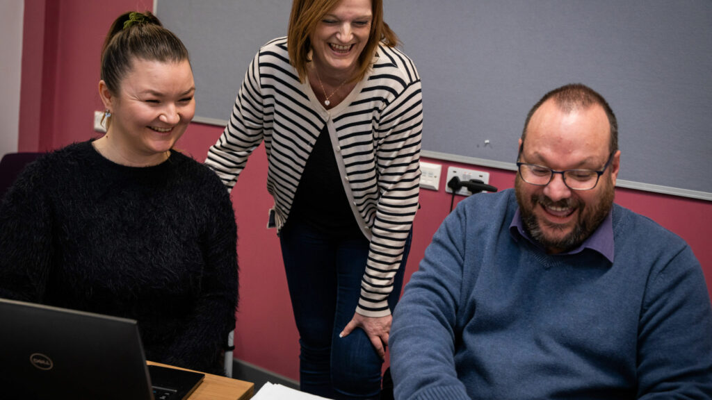 Two Business students sat smiling