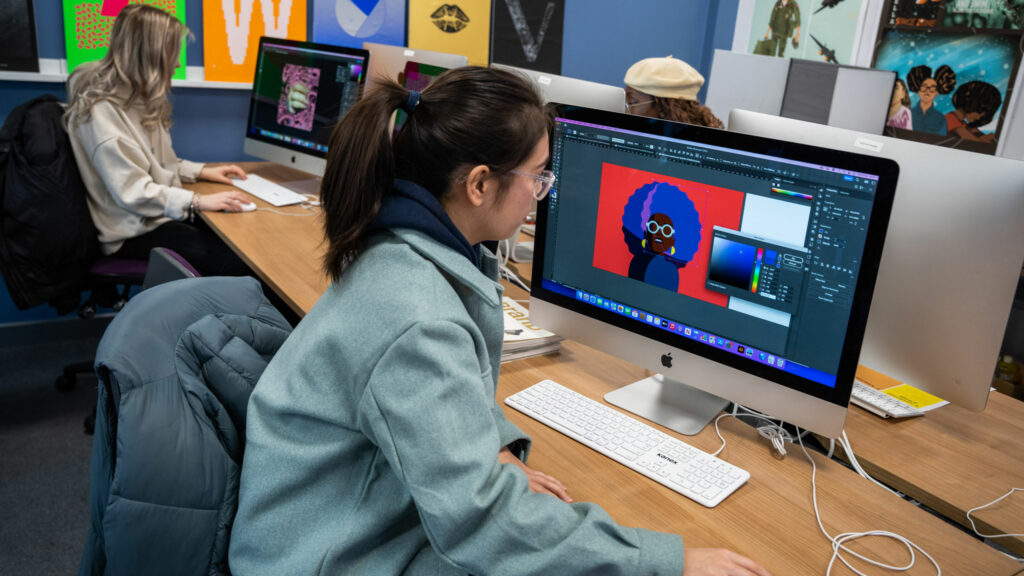 Graphic Design students designing art on computers