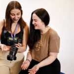 Two students looking at photos on a camera