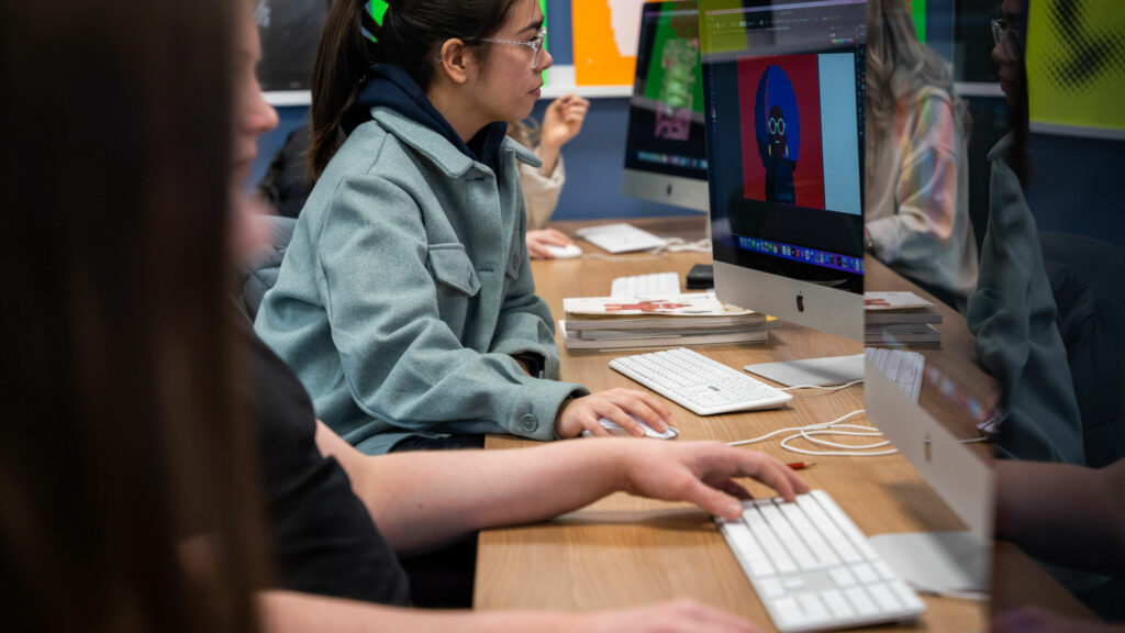 Graphic Design students sat working at computers