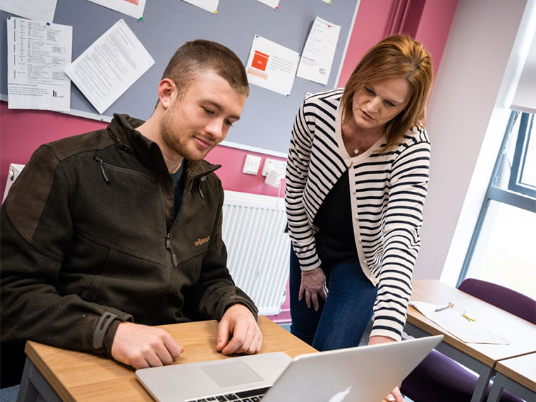 Two adults in a classroom