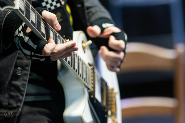 Close up of a student playing the guitar