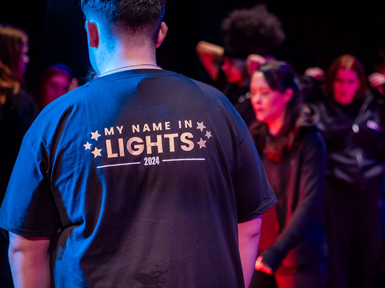 'My name in lights' written on the back of a student's tee shirt