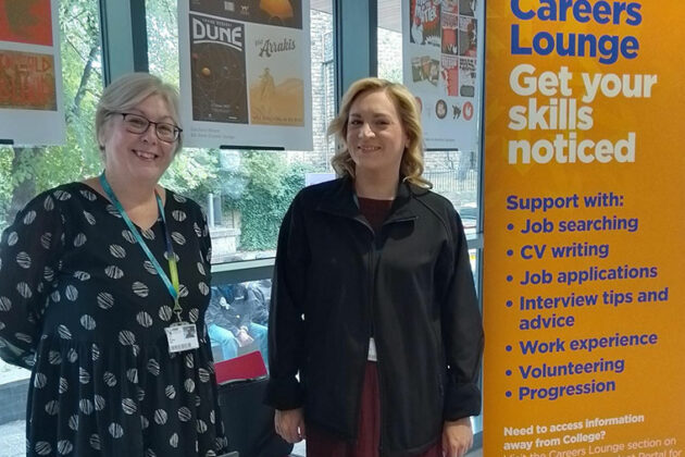 Careers staff stood next to a Careers Lounge banner
