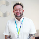 Conal White, Accounting Tutor - male with short dark hair wearing a white short sleeved shirt